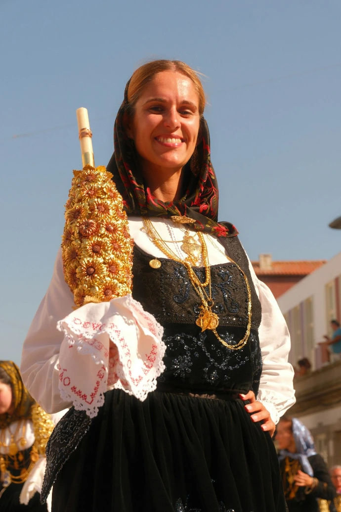 Woman in traditional dress holding a decorated object